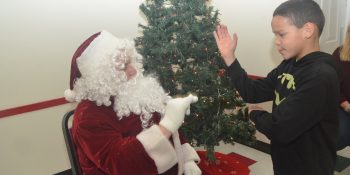 Santa sign-languages with one of the hearing impaired kids